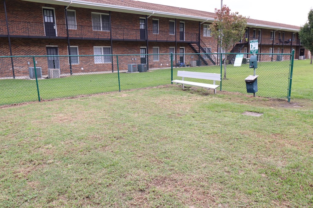 a bench in a park in front of a building
