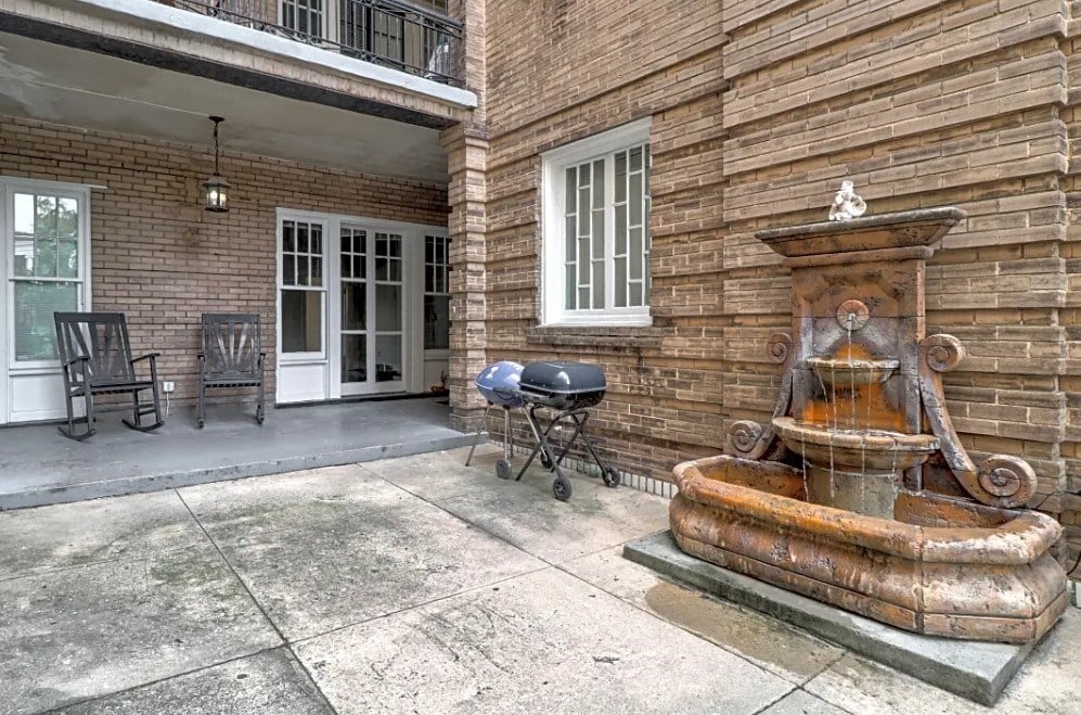 a water fountain outside of a brick building