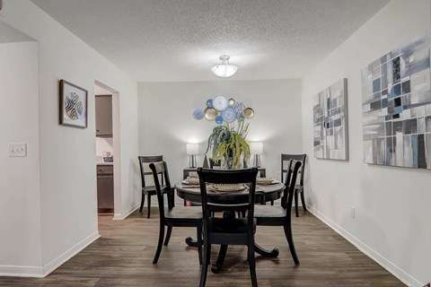 A dining room with a table set for four.
