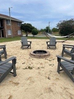 a fire pit sitting in the middle of a sandy area
