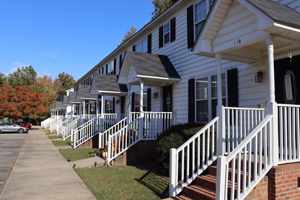 a row of white houses with white railings