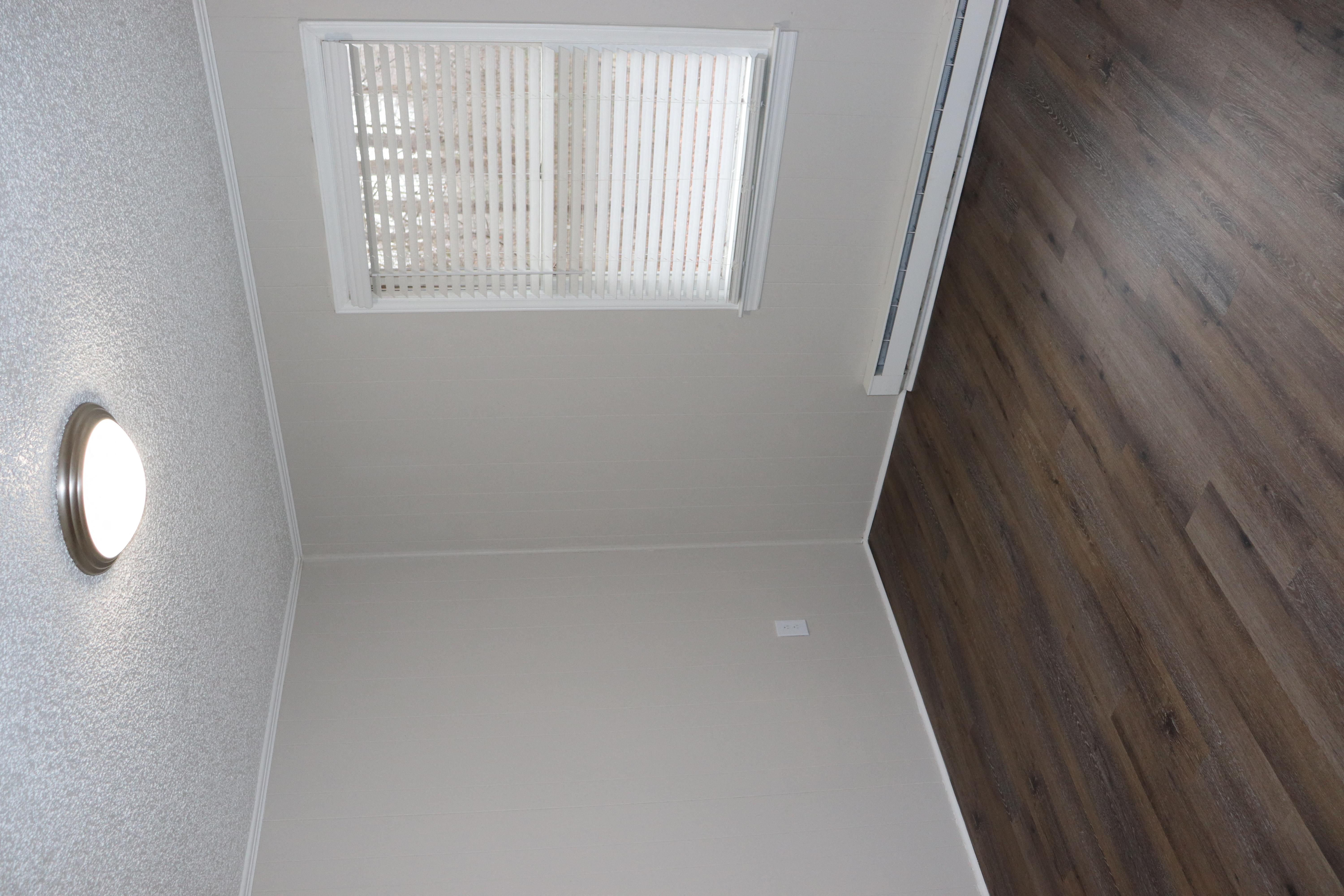 an overhead view of a hallway with wood flooring and a window