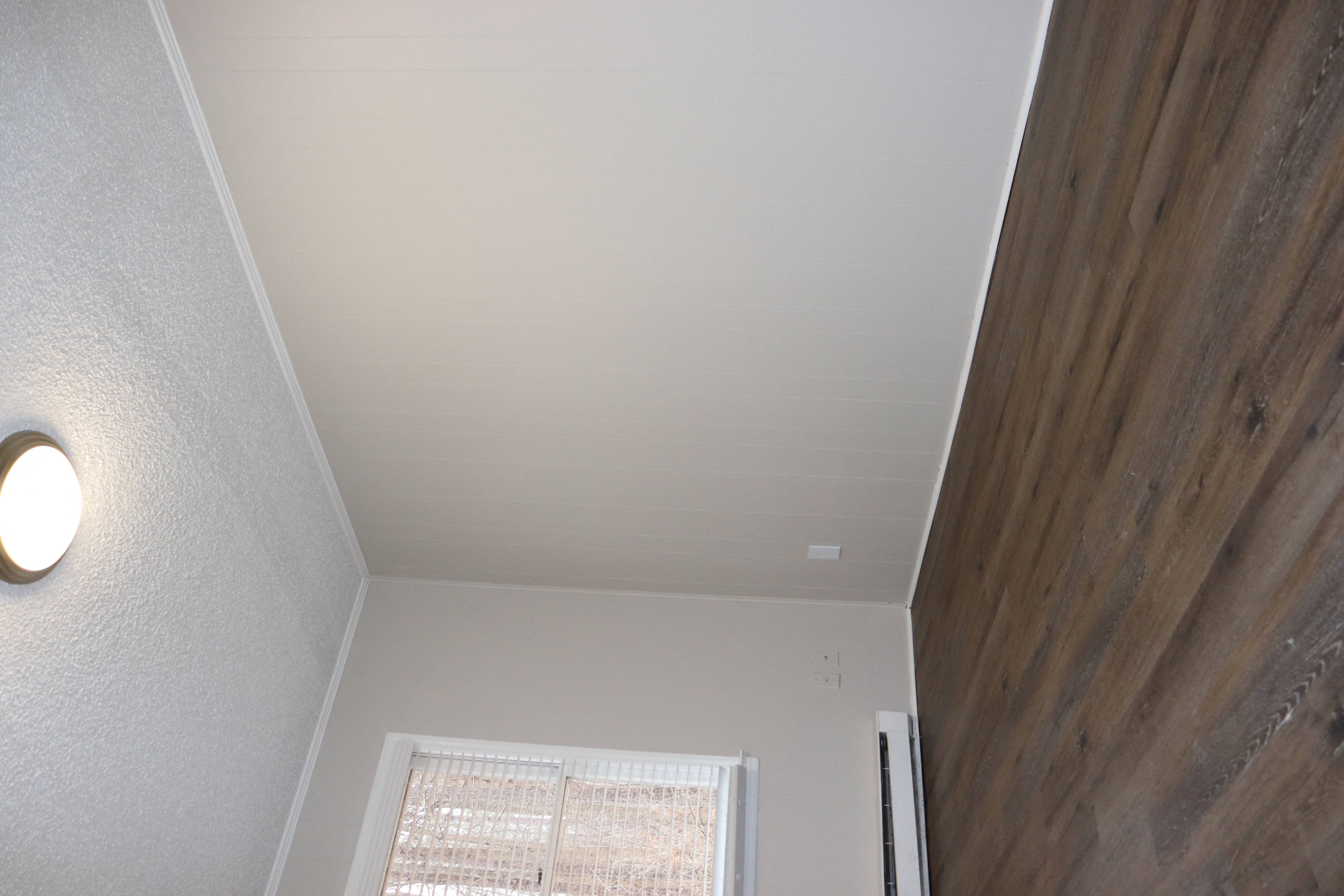 an overhead view of a room with a wooden wall and white ceiling
