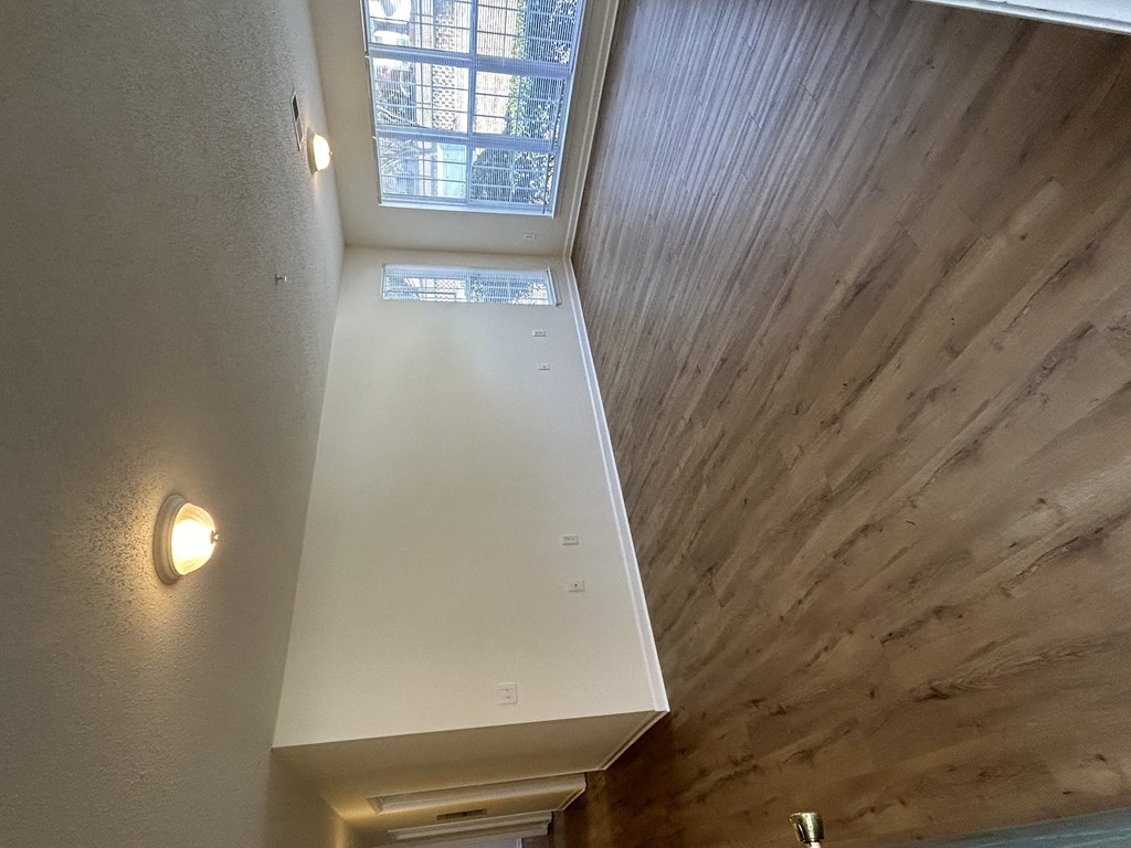 the view from the top of the stairs looking down into the loft of a home