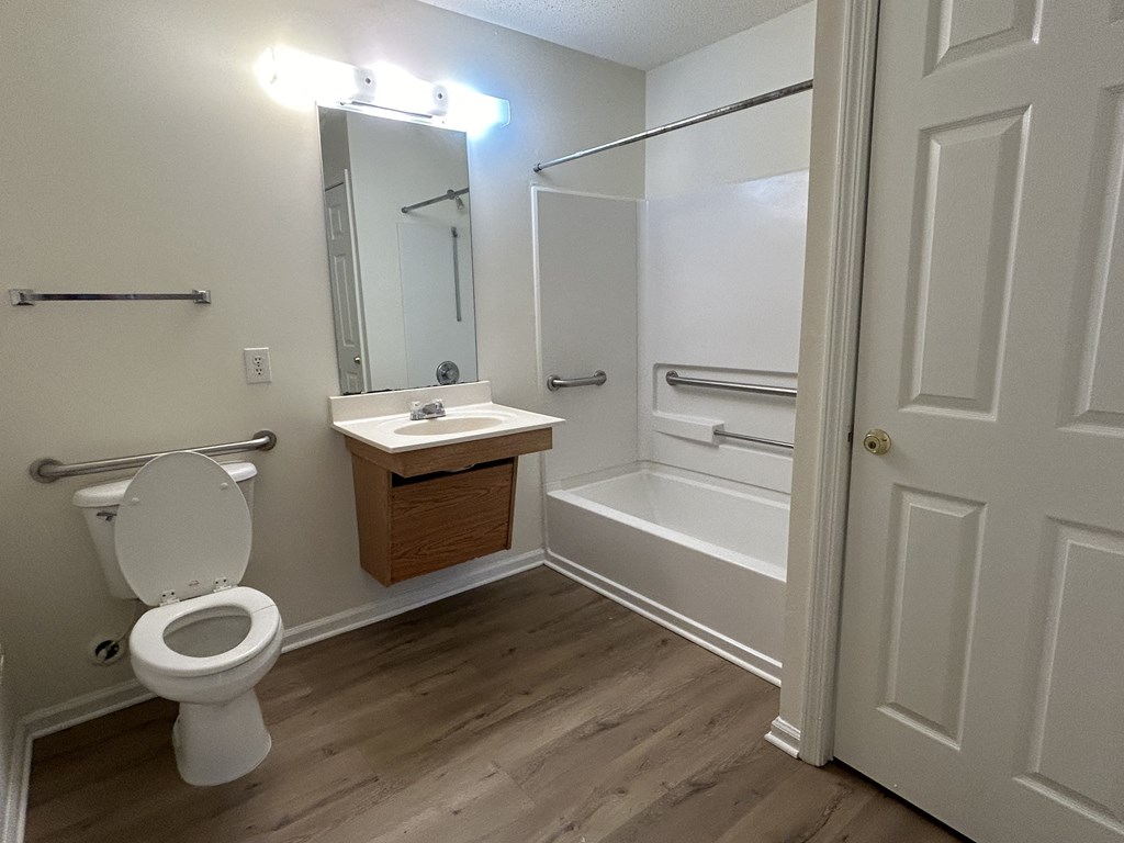 a bathroom with a toilet and a sink and a shower