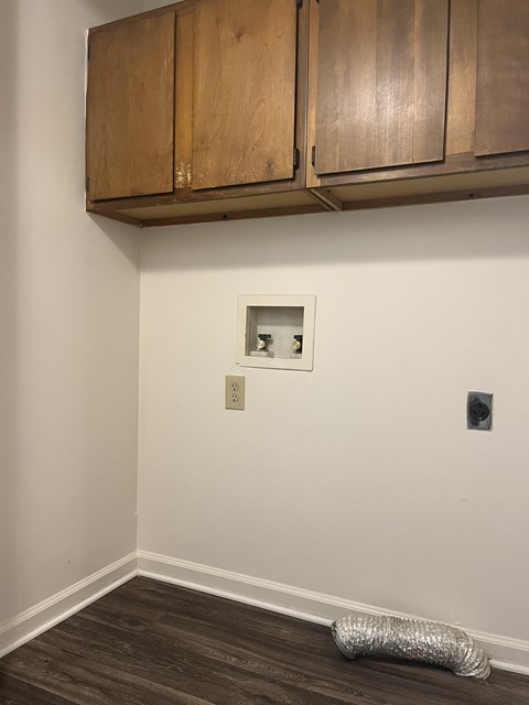A room with wooden cabinets and a picture frame on the wall.
