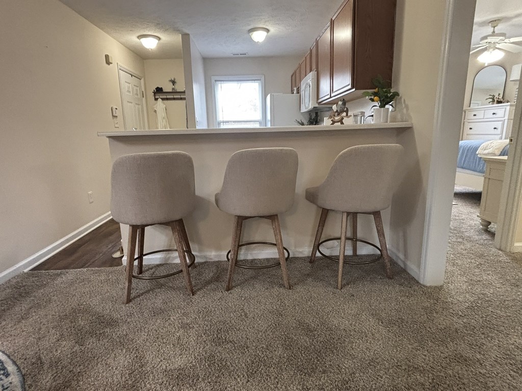 Three barstools are placed in front of a counter.