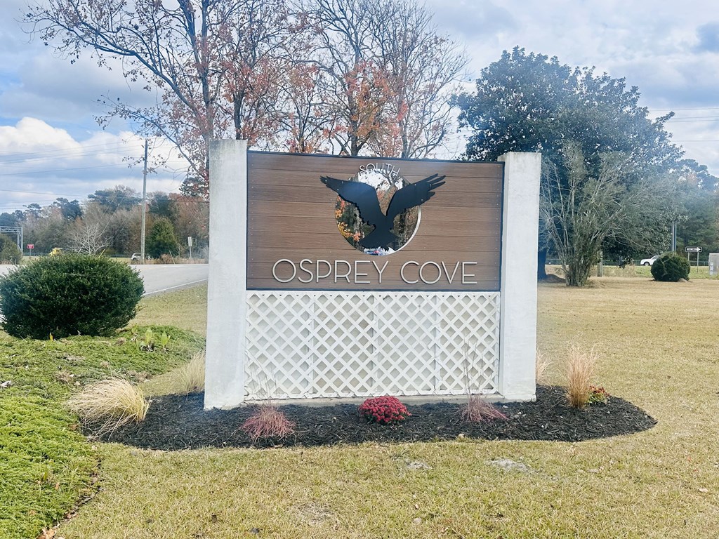 A sign that says "Osprey Cove" with a bird silhouette on it.