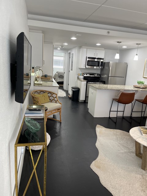 A modern kitchen with a white countertop and stainless steel appliances.at The Palms on Main, South Carolina, 29201