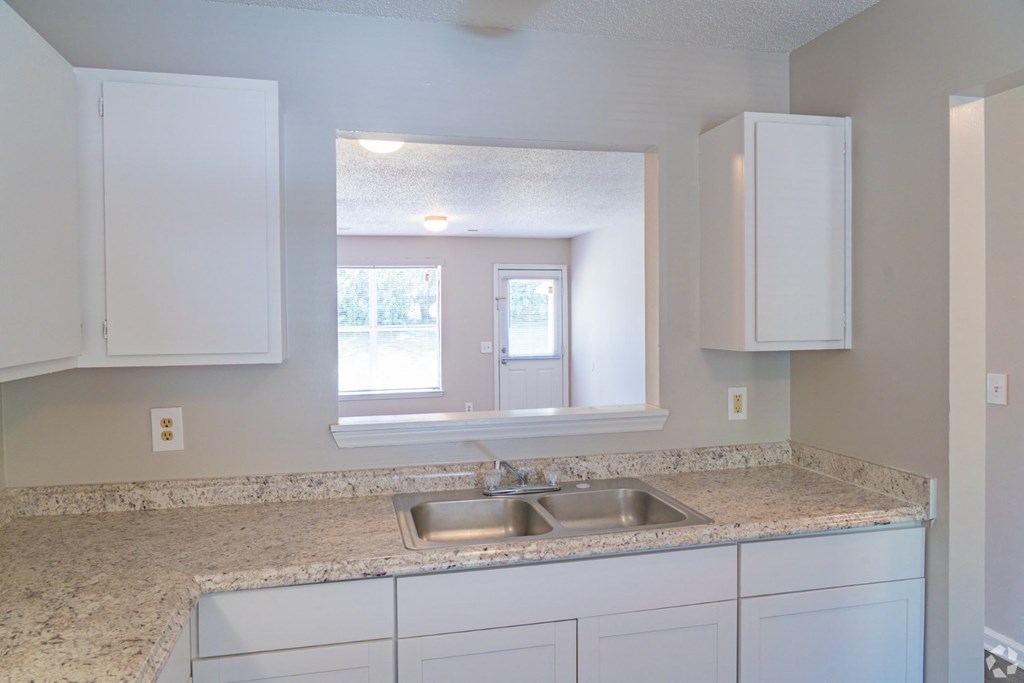 A kitchen with a sink and cabinets.