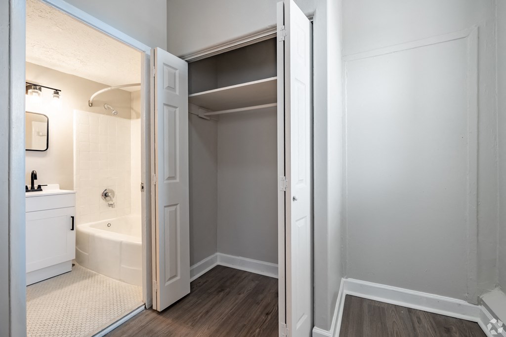 a bedroom with a medium sized bed and a mirror on the wall