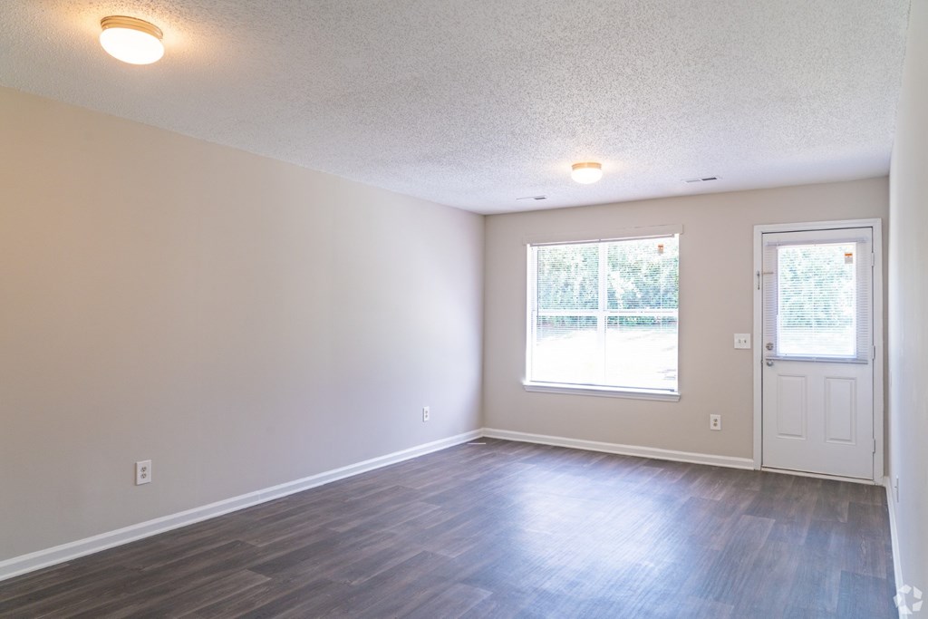 A room with a door, window, and light fixture.