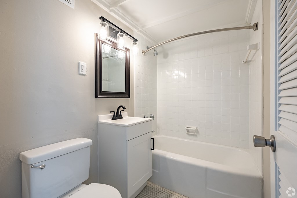 a bathroom with a toilet sink and bathtub