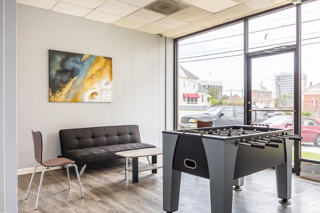 a room with a foosball table and a couch