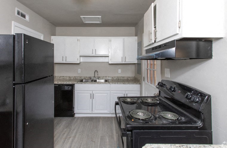 a kitchen with a stove and a refrigerator