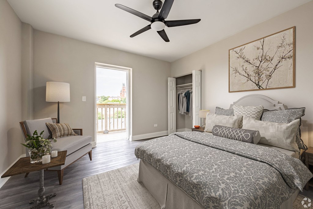 a bedroom with a large bed and a ceiling fan