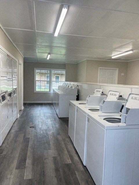an empty laundry room with white washing machines