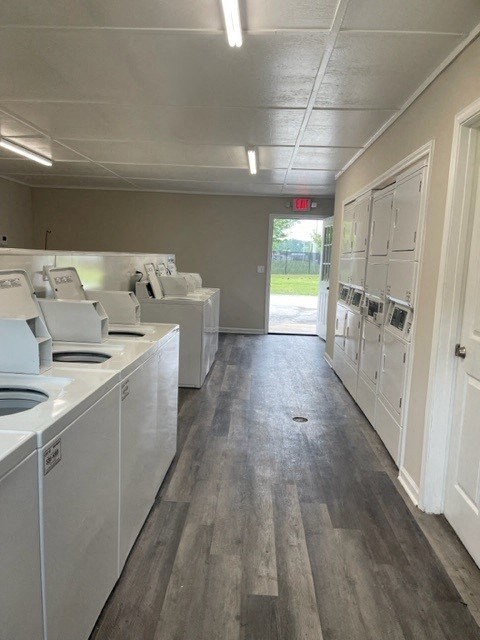 an empty laundry room with washing machines and sinks
