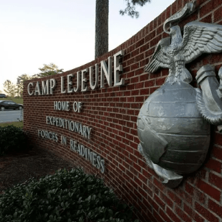 a sign on the side of a brick wall