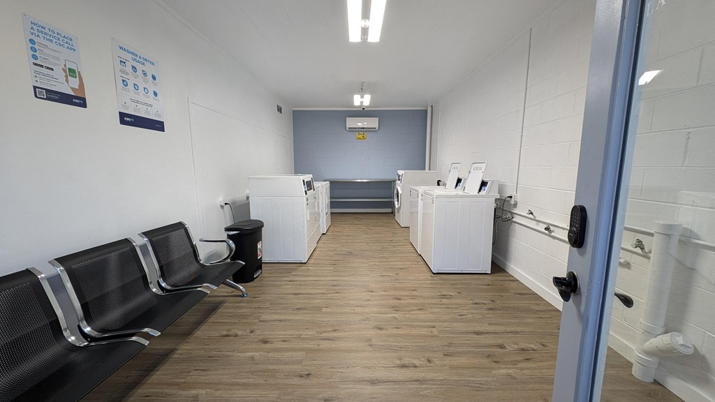 a break room with chairs and counters and a door