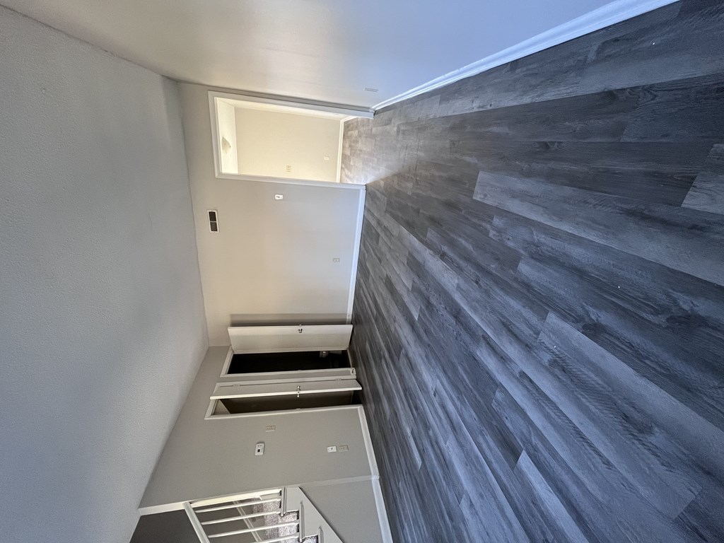 A wall of wood planks runs along the side of a room.