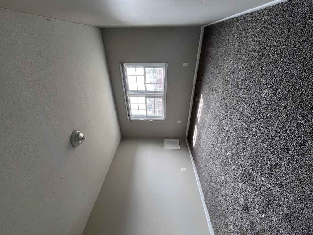 A small room with a window and a door.