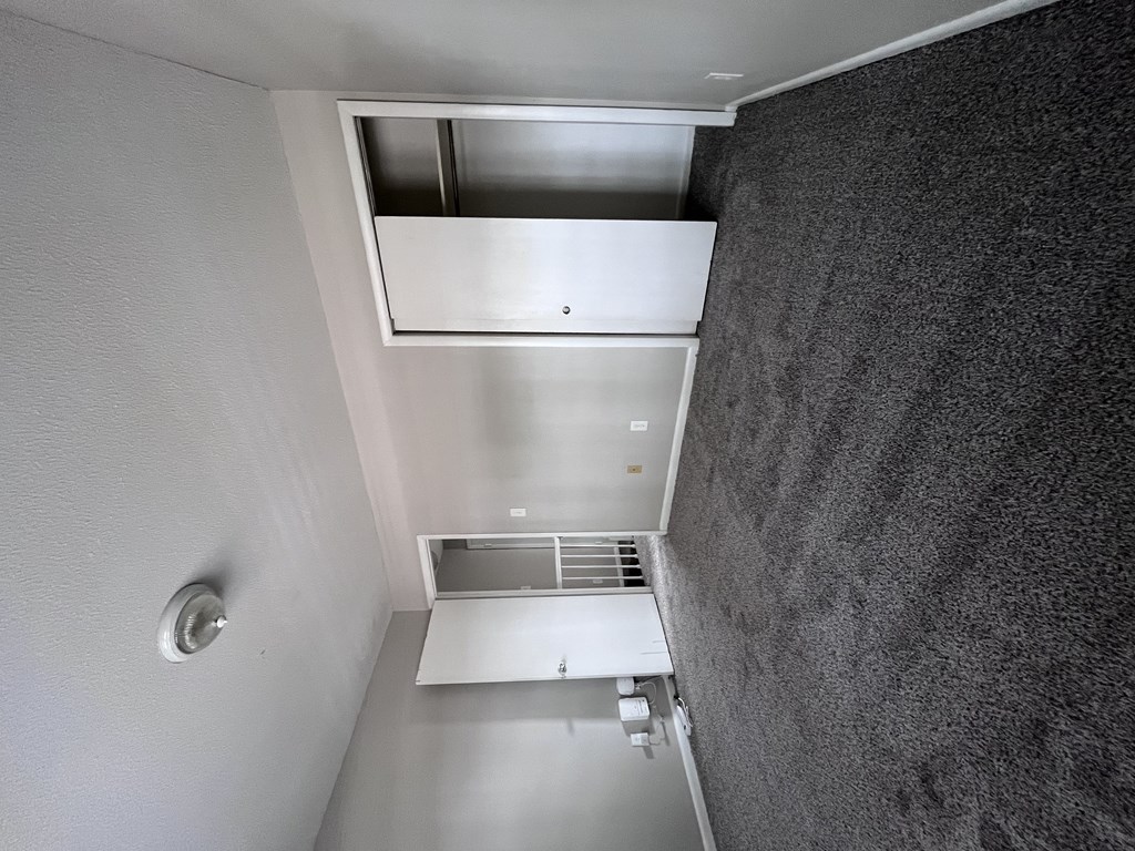 A wall-mounted air conditioner unit is installed in a room.