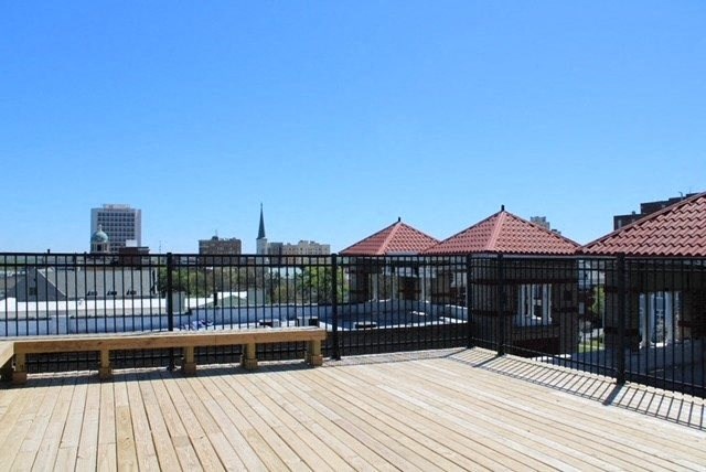 a wooden bench sitting on top of a wooden deck