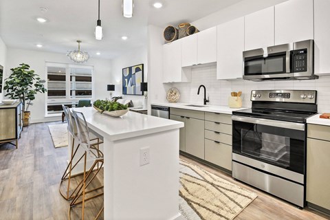 A modern kitchen with white cabinets and stainless steel appliances. at The Palms 1101, Columbia, SC, 29201