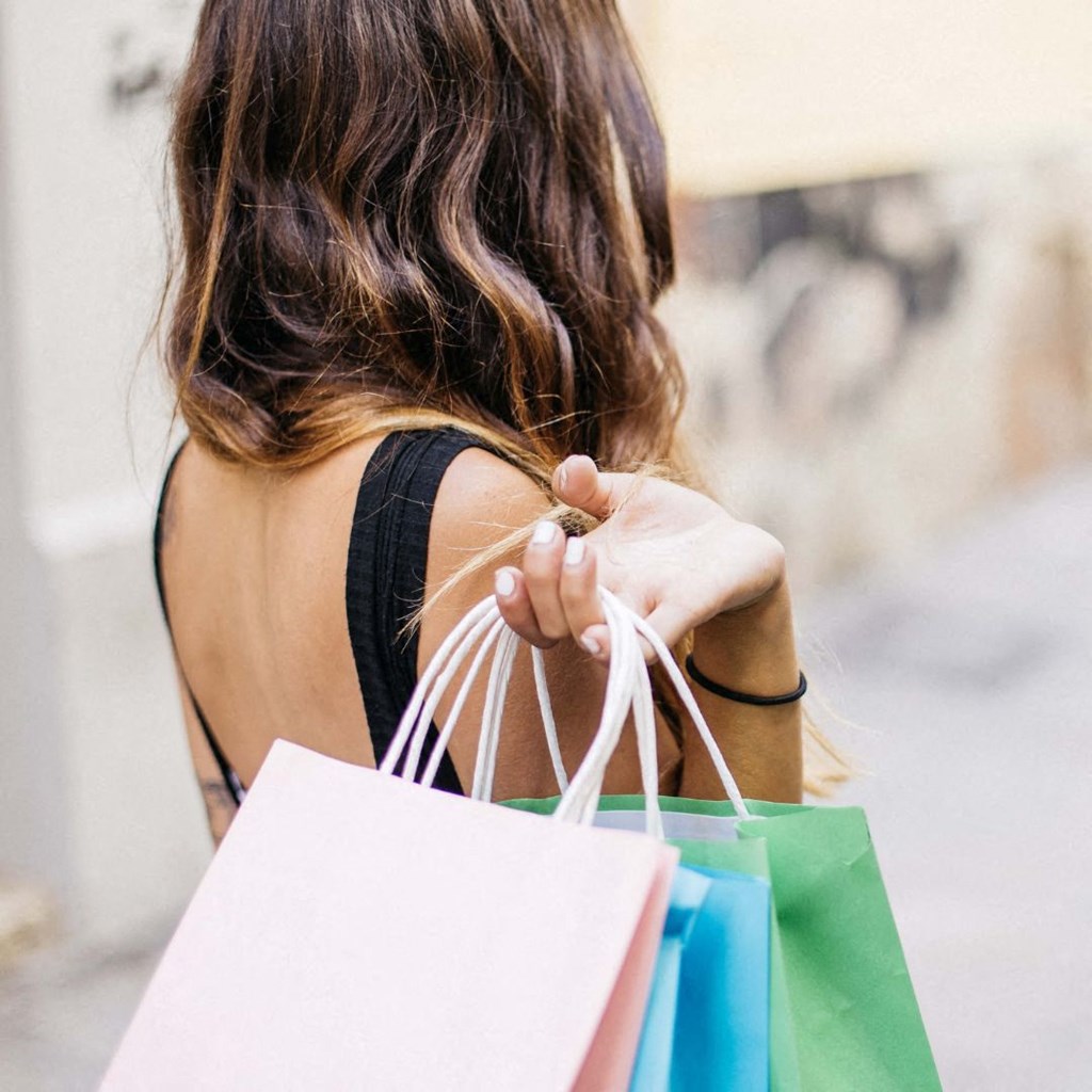 a woman carrying shopping bags and holding shopping bags
