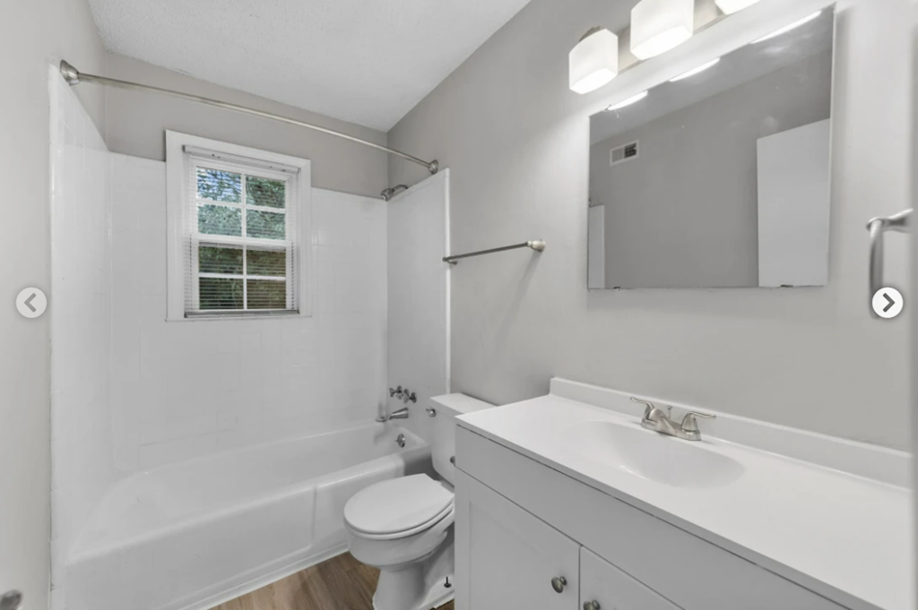 a bathroom with a sink toilet and a bath tub