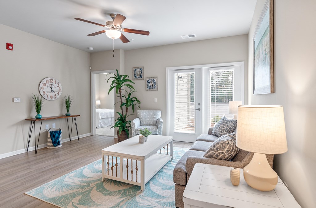 a living room with a ceiling fan and a couch