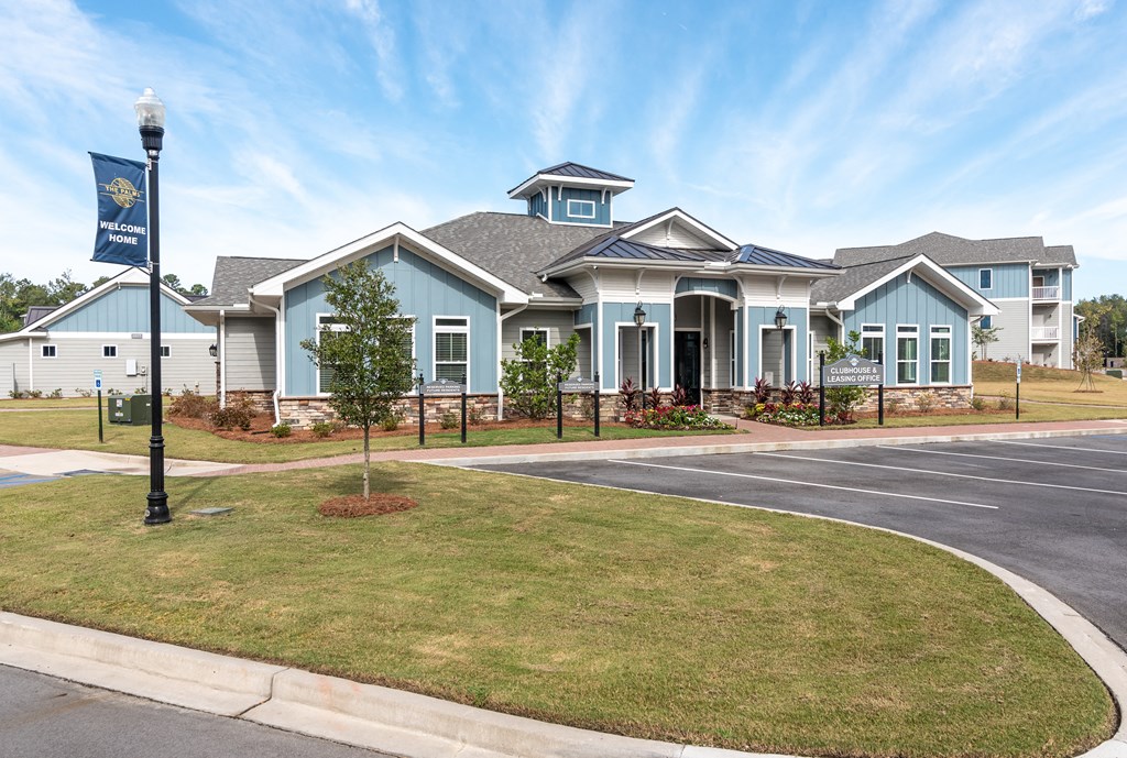a large blue house with a street sign in front of it
