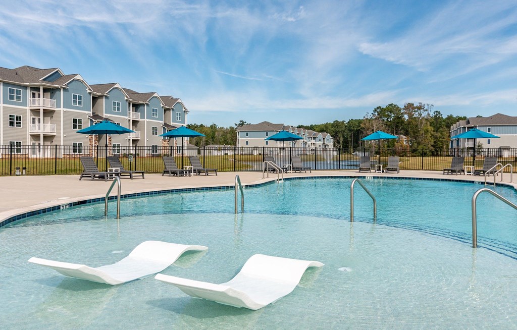 our apartments have a large pool with chairs and umbrellas