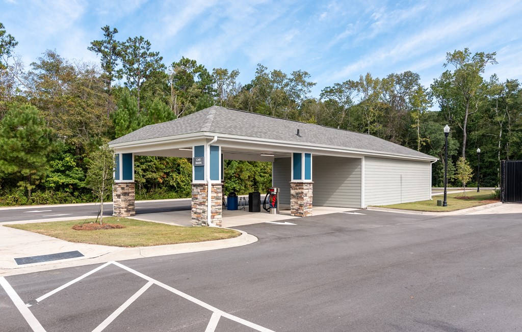a parking lot with a building with a covered parking lot