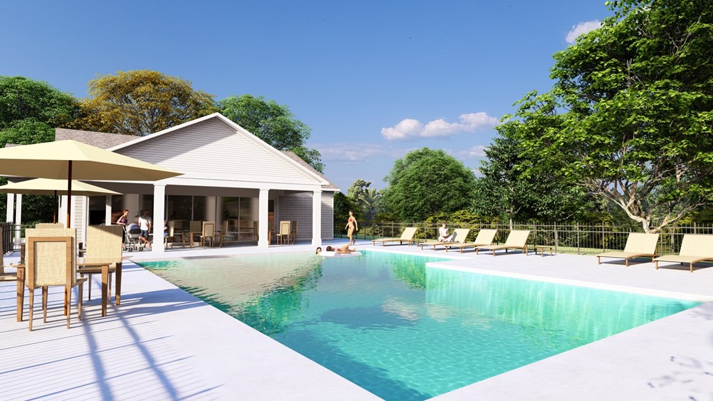 A poolside area with a house and trees in the background.