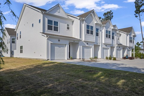 A white two story house with a garage.