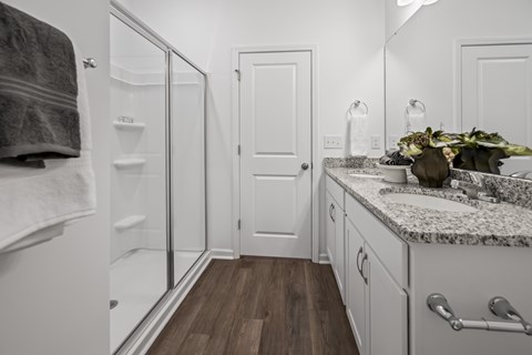 A bathroom with a white door and a marble counter.