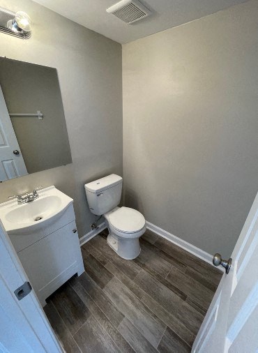 a bathroom with a toilet and a sink and a mirror