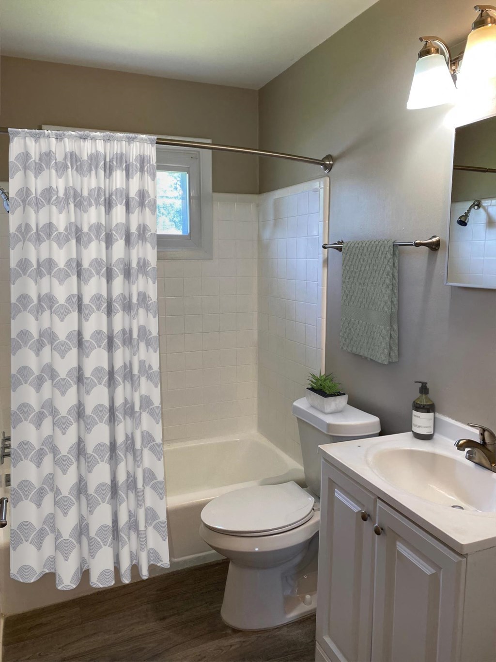 a bathroom with a shower curtain and a toilet and a sink