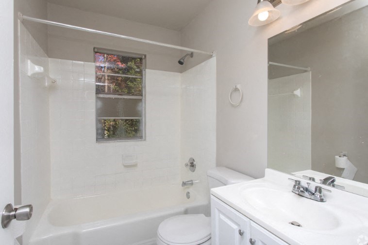 a bathroom with a sink toilet and a shower