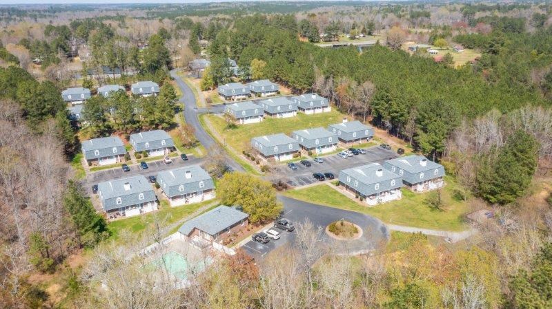 an aerial view of a group of houses in a field