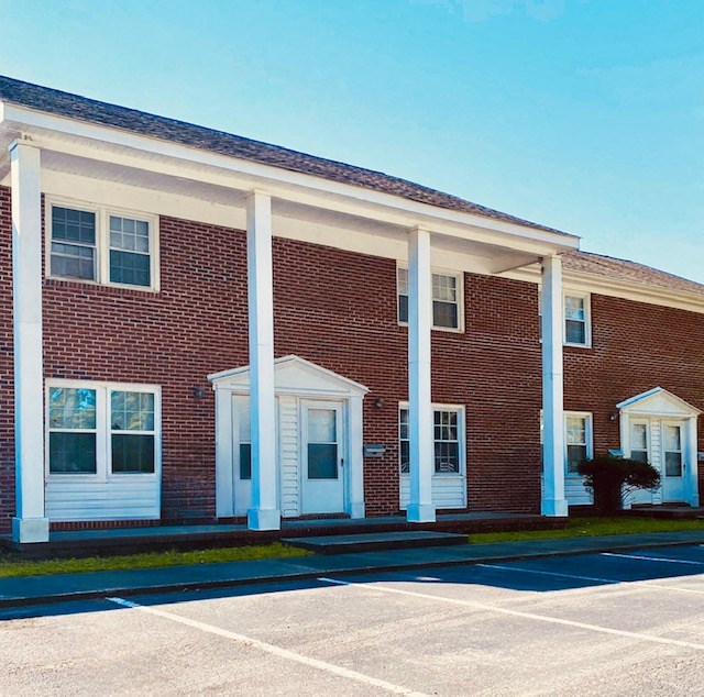 a brick building with white pillars