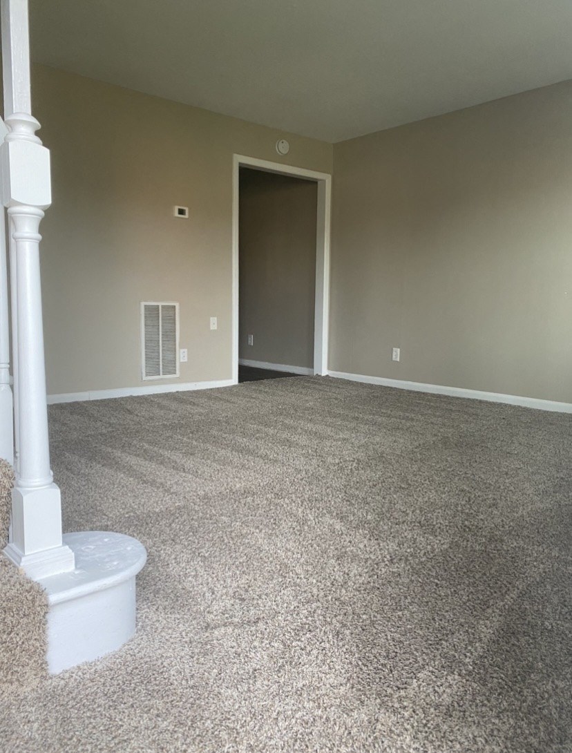 an empty room with a white post in the corner