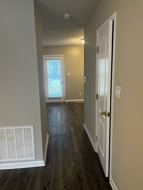 a hallway with a door and a white door