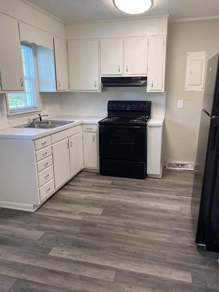 a kitchen with a stove a sink and a refrigerator