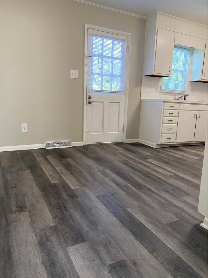 a kitchen with a door and a window
