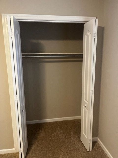 an empty closet with an open door