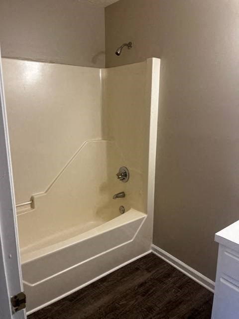 a white bathroom with a tub and a shower