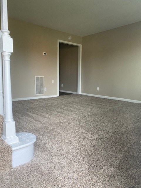 an empty room with a stairway and a doorway